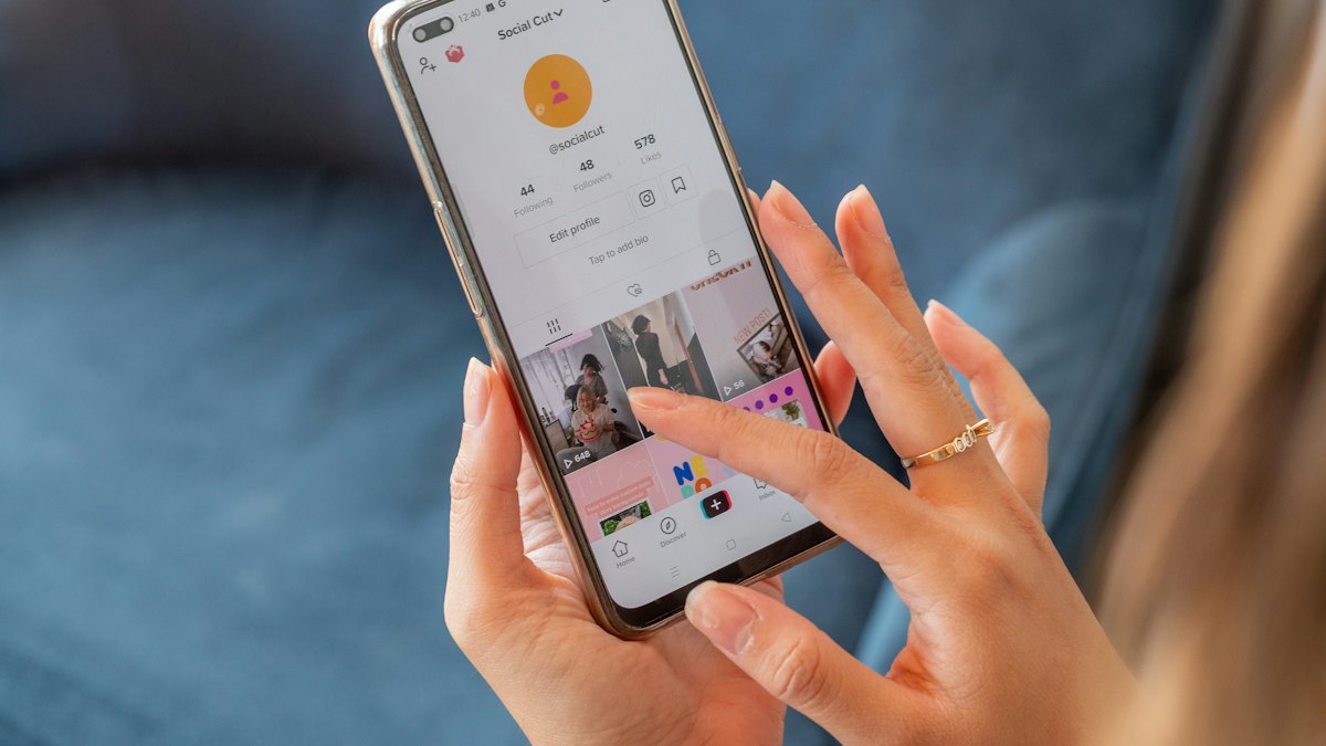 A woman holding a phone in her hand