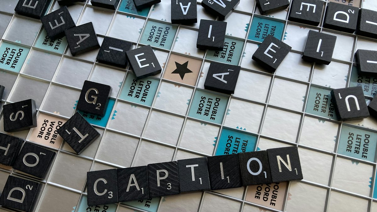 Scrabble tiles spelling the word caption