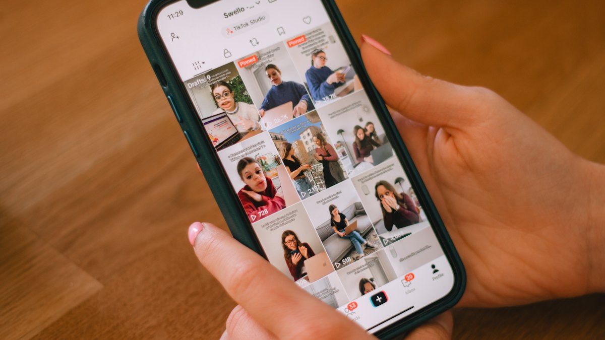 Someone scrolling through a TikTok feed on a phone