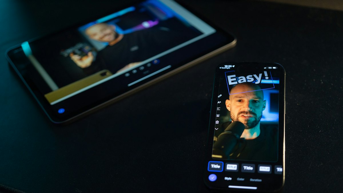A phone recording a man, with text overlaid on the video